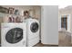 Bright laundry room featuring a modern washer and dryer, plus ample storage space at 8921 W Laurel Ln, Peoria, AZ 85345