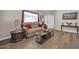 Cozy living room with wood flooring, neutral wall colors, and ample natural light streaming in through a door at 8921 W Laurel Ln, Peoria, AZ 85345