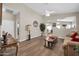 Cozy living area with wood flooring, a ceiling fan, a warm color scheme, and access to other rooms at 8921 W Laurel Ln, Peoria, AZ 85345