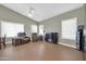 A neutral living room with wood-look floors, vaulted ceiling and fan, and recliners for relaxing at 8921 W Laurel Ln, Peoria, AZ 85345