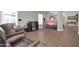 A living room featuring wood-look floors and a large television for entertaining guests and relaxing at 8921 W Laurel Ln, Peoria, AZ 85345