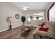 Bright living room featuring hardwood floors, neutral wall colors, a ceiling fan, and an open layout at 8921 W Laurel Ln, Peoria, AZ 85345