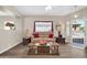 Comfortable living room featuring stylish wood floors, neutral paint, and a bright window at 8921 W Laurel Ln, Peoria, AZ 85345