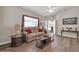 Bright living room featuring modern flooring, neutral wall colors, ceiling fan, and an airy atmosphere at 8921 W Laurel Ln, Peoria, AZ 85345