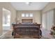 A main bedroom features a large bed, side tables, and neutral walls at 8921 W Laurel Ln, Peoria, AZ 85345
