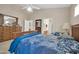 A main bedroom with a large bed, dresser, and doorway that leads to an adjoining bathroom at 8921 W Laurel Ln, Peoria, AZ 85345