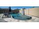 Sparkling backyard pool with lounge chairs, umbrellas, and privacy fencing at 9936 E Revolution Dr, Mesa, AZ 85212