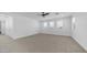Bright, spacious bedroom with large windows providing natural light and carpeted floor at 9936 E Revolution Dr, Mesa, AZ 85212