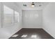 Empty bedroom with hardwood floors and white shuttered windows at 9936 E Revolution Dr, Mesa, AZ 85212