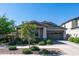 Charming single-story home with a two-car garage, manicured landscaping, and a welcoming curb appeal at 9936 E Revolution Dr, Mesa, AZ 85212