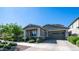 Charming single-story home with a well-manicured lawn and inviting curb appeal at 9936 E Revolution Dr, Mesa, AZ 85212