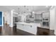 Modern kitchen with stainless steel appliances, a large island, and beautiful backsplash at 9936 E Revolution Dr, Mesa, AZ 85212