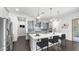 Modern kitchen with a large center island, stainless steel appliances, and stylish pendant lighting at 9936 E Revolution Dr, Mesa, AZ 85212