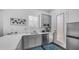 Cozy kitchenette with stainless steel appliances, white cabinets, and quartz countertops at 9936 E Revolution Dr, Mesa, AZ 85212