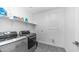Well-equipped laundry room featuring modern washer and dryer set and convenient shelf at 9936 E Revolution Dr, Mesa, AZ 85212