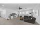 Spacious living room with neutral tones, plush carpet, and plenty of natural light at 9936 E Revolution Dr, Mesa, AZ 85212