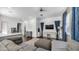 Bright living room features a modern ceiling fan, neutral paint, and contemporary decor at 9936 E Revolution Dr, Mesa, AZ 85212