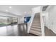 Spacious living area featuring a staircase, large windows, and patio access at 9936 E Revolution Dr, Mesa, AZ 85212