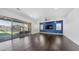 Open living space with a sliding glass door leading to the backyard and a statement wall at 9936 E Revolution Dr, Mesa, AZ 85212