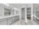 Bathroom featuring double sinks, tile flooring, and large mirror at 9936 E Revolution Dr, Mesa, AZ 85212