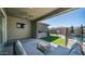 Relaxing outdoor living space with comfortable seating, built-in grill, and a view of the pool at 9936 E Revolution Dr, Mesa, AZ 85212
