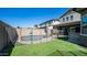 Backyard view showcasing a fenced swimming pool, lounge chairs, and well-maintained artificial grass at 9936 E Revolution Dr, Mesa, AZ 85212