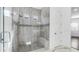 Beautiful walk-in shower with glass door, mosaic tile accents, and built-in bench at 9936 E Revolution Dr, Mesa, AZ 85212