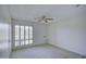 Cozy bedroom with a ceiling fan and shuttered windows allowing natural light to illuminate the space at 10020 W Royal Oak Rd # F, Sun City, AZ 85351