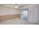 Bright bedroom featuring a ceiling fan and open access to a sunroom with sliding glass doors at 10020 W Royal Oak Rd # F, Sun City, AZ 85351