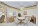 Bright dining area featuring a ceiling fan and seating for four at 10020 W Royal Oak Rd # F, Sun City, AZ 85351
