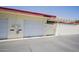 The garage features a white door, utility meters, and access to a gated outdoor space at 10020 W Royal Oak Rd # F, Sun City, AZ 85351