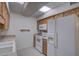 Bright kitchen features ample oak cabinet storage, modern appliances, and a double basin sink at 10020 W Royal Oak Rd # F, Sun City, AZ 85351