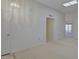 Spacious living room with neutral carpeting, lighting fixture, and an open layout leading to other areas of the home at 10020 W Royal Oak Rd # F, Sun City, AZ 85351