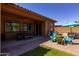 Backyard featuring a covered patio with outdoor seating, a ping pong table, and a grassy area at 10402 E Starion Ave, Mesa, AZ 85212
