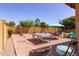 Spacious backyard featuring a ping pong table, seating area, and shuffleboard, perfect for outdoor activities at 10402 E Starion Ave, Mesa, AZ 85212
