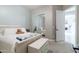 Bedroom showcasing a queen bed with a sliding mirror closet, a chest of drawers and view to hall at 10402 E Starion Ave, Mesa, AZ 85212