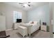 A charming bedroom featuring a queen bed, shuttered window, and complementing dresser and nightstand at 10402 E Starion Ave, Mesa, AZ 85212