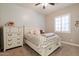 Bright bedroom featuring a queen bed with storage drawers and a decorative chevron patterned comforter at 10402 E Starion Ave, Mesa, AZ 85212