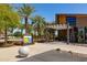 Community entrance featuring landscaping, signage, and covered walkway to the community building at 10402 E Starion Ave, Mesa, AZ 85212