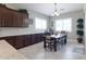 Charming dining area featuring a wooden table, stylish chairs, plantation shutters, and tile flooring at 10402 E Starion Ave, Mesa, AZ 85212