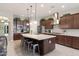 Spacious kitchen with granite countertops, stainless steel appliances, and a central island with seating at 10402 E Starion Ave, Mesa, AZ 85212