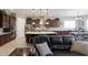 Open-concept kitchen and living area with stainless appliances, granite countertops, and dark wood cabinets at 10402 E Starion Ave, Mesa, AZ 85212
