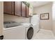 Functional laundry room equipped with Samsung washer and dryer and storage cabinets at 10402 E Starion Ave, Mesa, AZ 85212