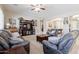 Spacious living room with plush seating, ceiling fan, and entertainment center at 10402 E Starion Ave, Mesa, AZ 85212