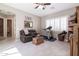 Comfortable living room with a leather couch, treadmill, and bright window at 10402 E Starion Ave, Mesa, AZ 85212