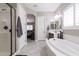 Well-lit bathroom featuring a soaking tub, glass-enclosed shower, and dual vanities at 10402 E Starion Ave, Mesa, AZ 85212