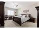 Serene main bedroom with a ceiling fan, desk, and a comfortable bed with lots of pillows at 10402 E Starion Ave, Mesa, AZ 85212