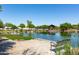 Scenic pond with a covered pavilion and walking path, enhancing the community's natural beauty at 10402 E Starion Ave, Mesa, AZ 85212