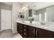 Bathroom featuring a dual sink vanity with dark cabinetry, tile flooring and bright lighting at 11127 E Tripoli Ave, Mesa, AZ 85212