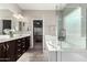 Bright bathroom featuring a dual sink vanity, soaking tub, and separate shower at 11127 E Tripoli Ave, Mesa, AZ 85212
